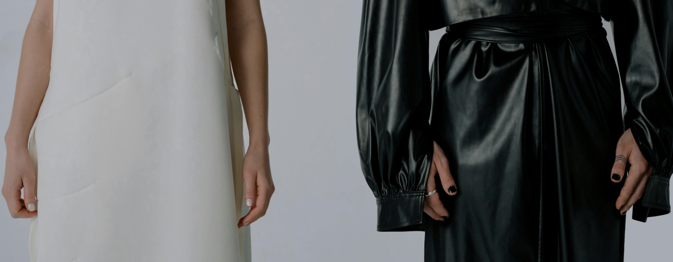 Two models wearing white and black designer garments